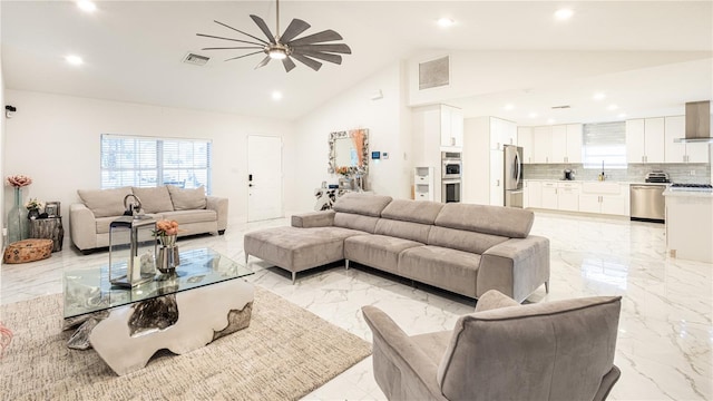 living room featuring sink and high vaulted ceiling