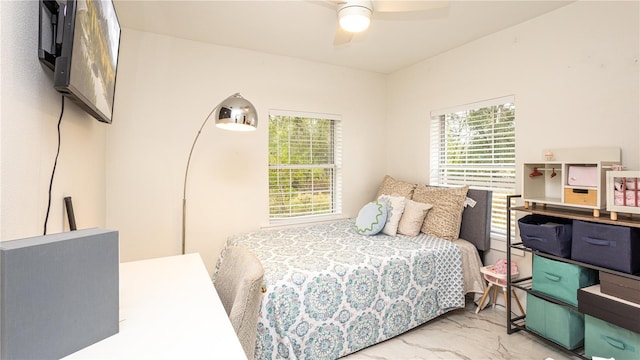 bedroom featuring multiple windows and ceiling fan