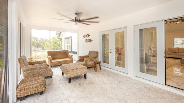 sunroom / solarium featuring french doors and ceiling fan