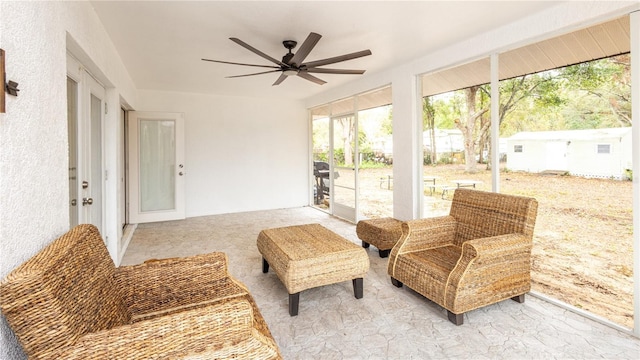 sunroom featuring ceiling fan