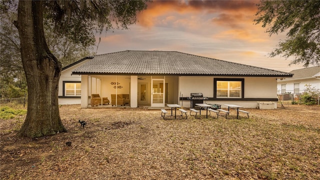 back house at dusk with ceiling fan