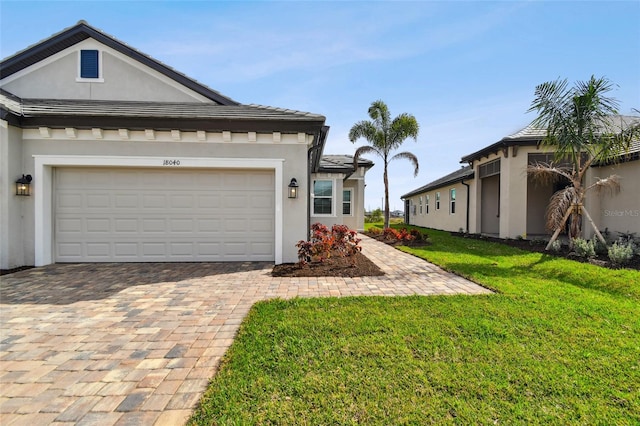 view of front of house with a garage and a front lawn