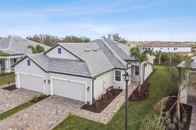 view of front of property with a garage and a front lawn