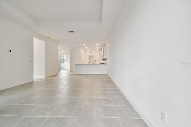 unfurnished living room featuring light tile patterned floors