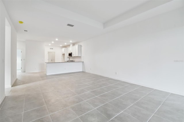 unfurnished living room with light tile patterned floors