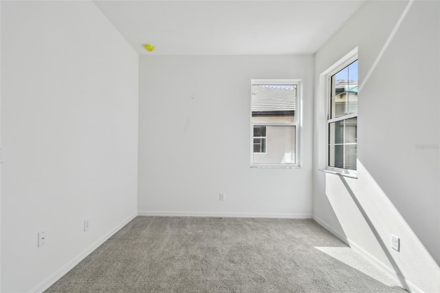 unfurnished room featuring light carpet