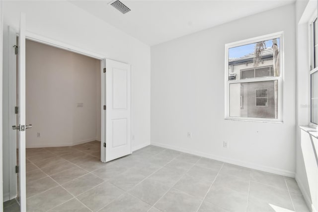 unfurnished bedroom with light tile patterned floors