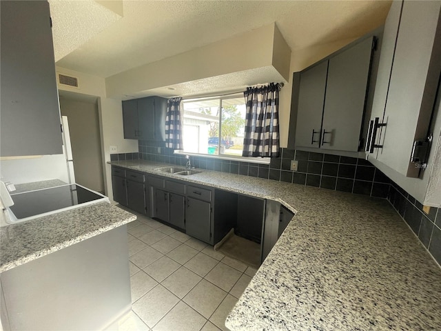 kitchen with gray cabinets, sink, and decorative backsplash