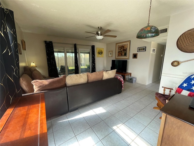 living room featuring a textured ceiling and ceiling fan