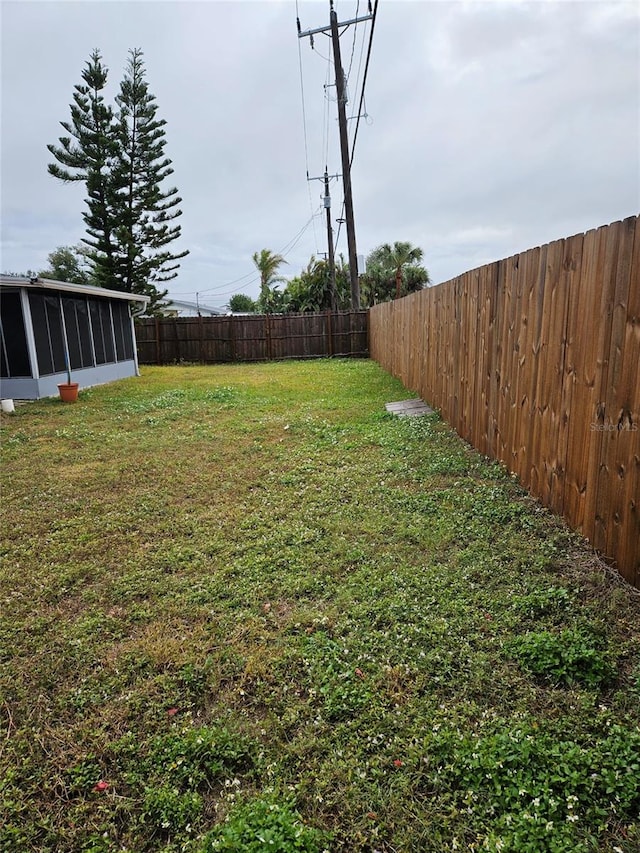 view of yard with a sunroom