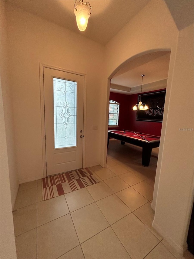 foyer entrance featuring tile patterned flooring, a raised ceiling, and billiards