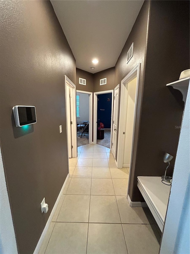 hall with light tile patterned floors