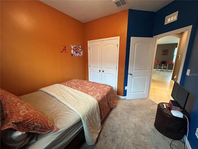 carpeted bedroom with a closet