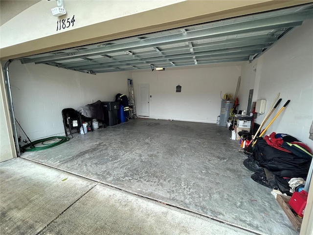 garage with water heater and a garage door opener