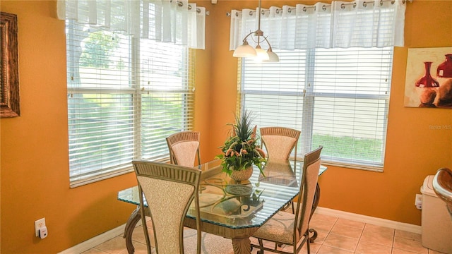 dining area with a wealth of natural light and light tile patterned flooring