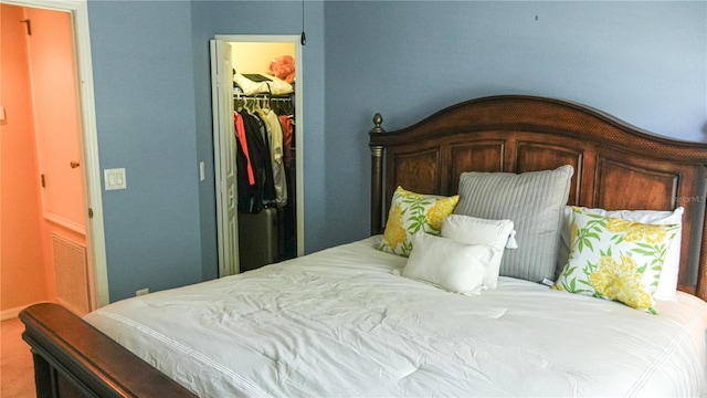 bedroom with a spacious closet and a closet