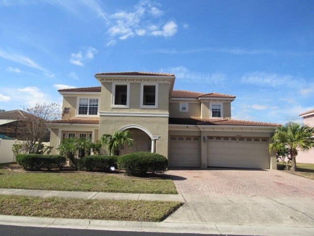 mediterranean / spanish-style house featuring a garage