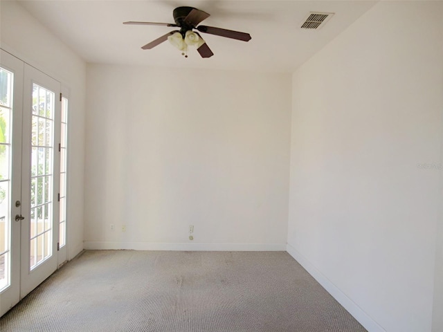 unfurnished room with visible vents, light carpet, french doors, baseboards, and ceiling fan