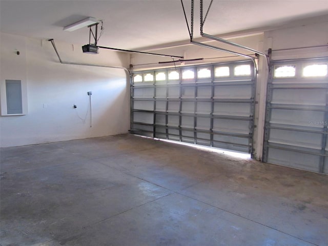 garage with electric panel and a garage door opener