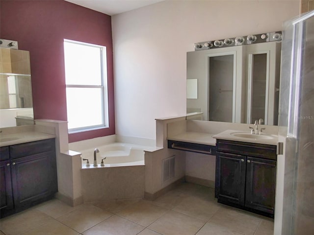 full bath with visible vents, two vanities, a sink, tile patterned flooring, and a bath