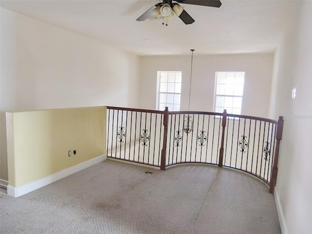 unfurnished room with carpet, baseboards, and ceiling fan