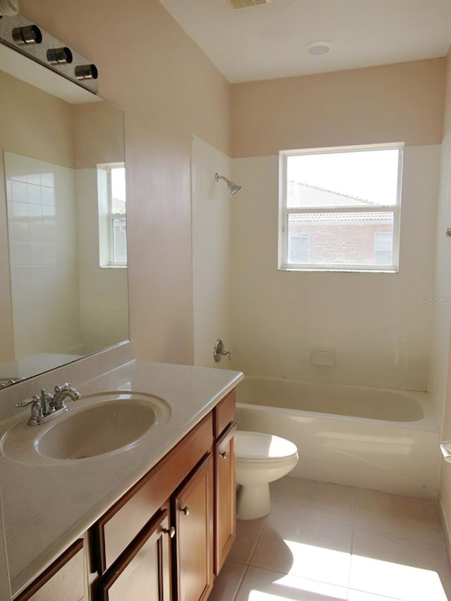 full bathroom with tile patterned flooring, toilet, plenty of natural light, and shower / tub combination