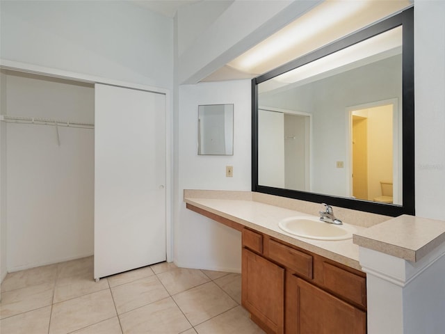 bathroom with tile patterned flooring, vanity, and toilet