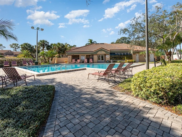 view of swimming pool featuring a patio area