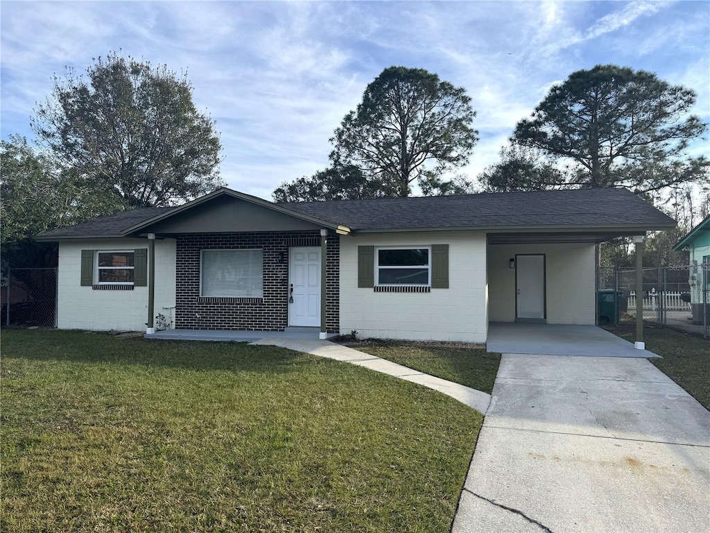 ranch-style home with a carport and a front lawn