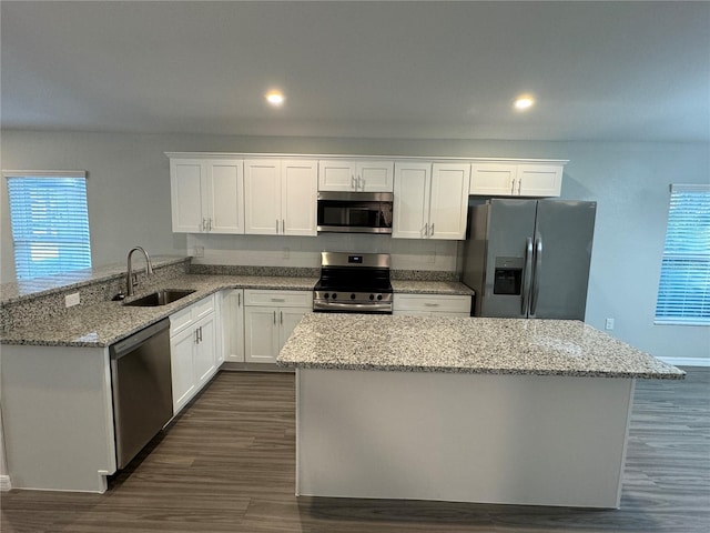 kitchen featuring white cabinetry, sink, light stone counters, and appliances with stainless steel finishes