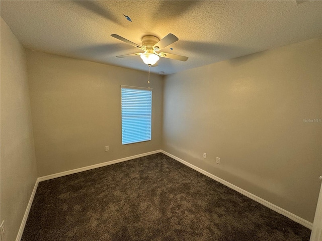 empty room with ceiling fan, carpet floors, and a textured ceiling