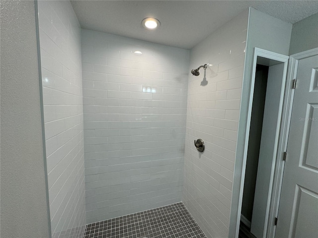 bathroom with tiled shower