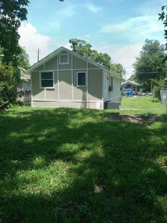 view of side of home with a lawn