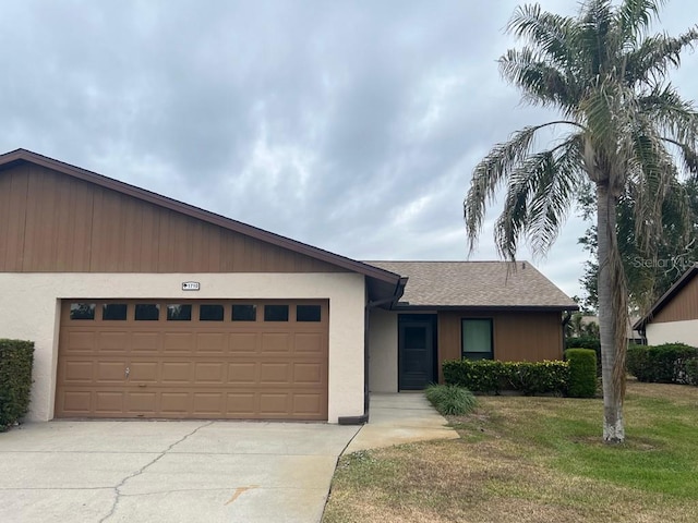 single story home featuring a garage and a front yard