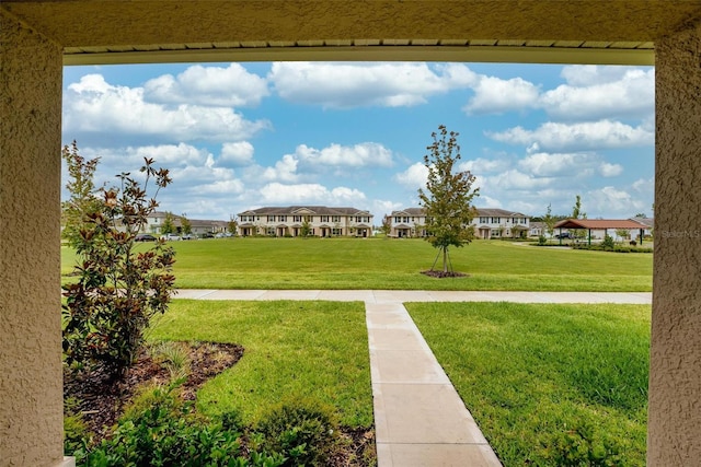 view of property's community with a yard