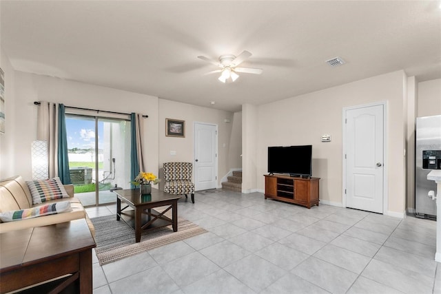 tiled living room with ceiling fan