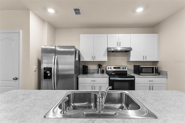 kitchen featuring sink, white cabinets, and appliances with stainless steel finishes