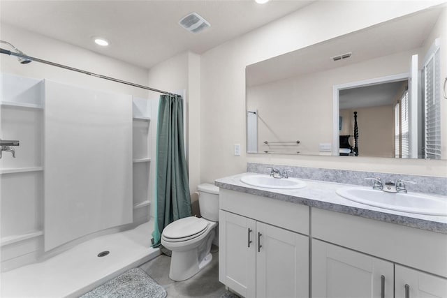 bathroom featuring vanity, curtained shower, and toilet