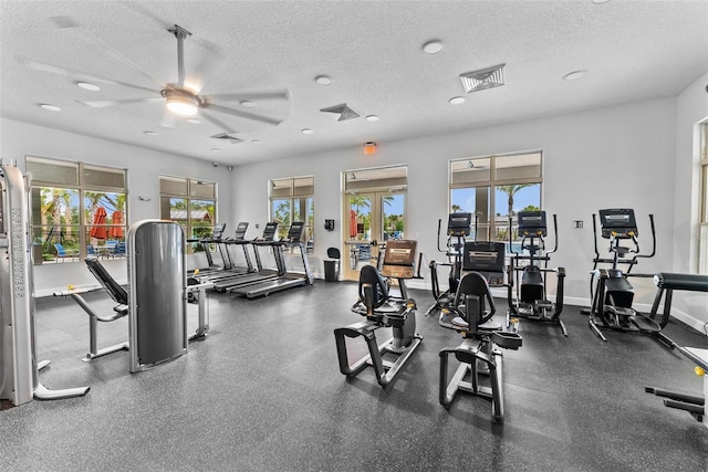 workout area with french doors, ceiling fan, and a textured ceiling