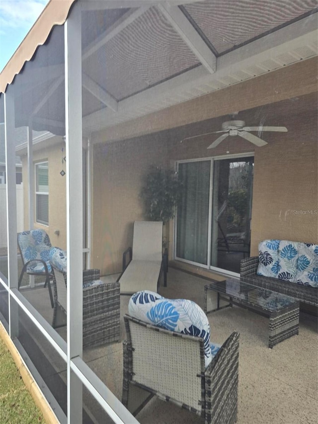 view of patio with a sunroom, outdoor lounge area, and ceiling fan