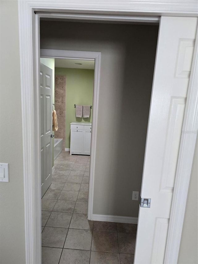 corridor with light tile patterned flooring