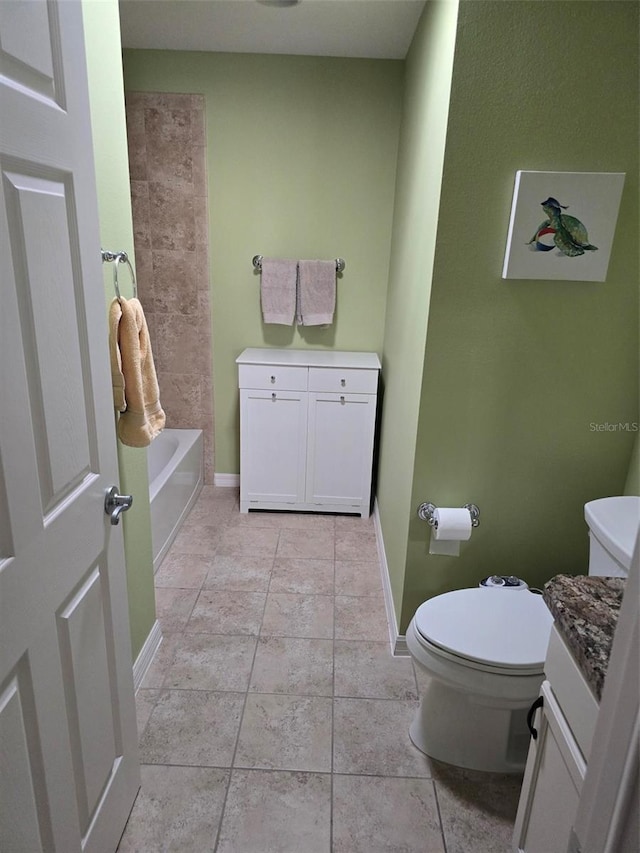 bathroom with vanity, tile patterned floors, and toilet