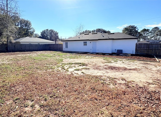 back of property with central AC