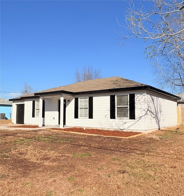 single story home with cooling unit and a front yard