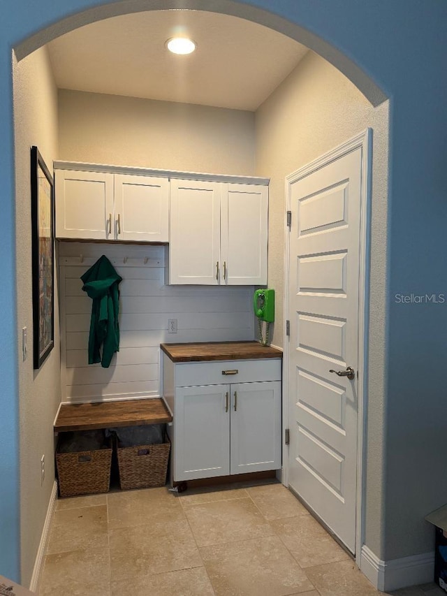 kitchen with white cabinetry and wooden counters