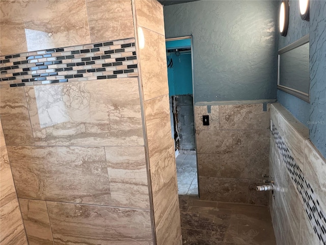 bathroom with tiled shower