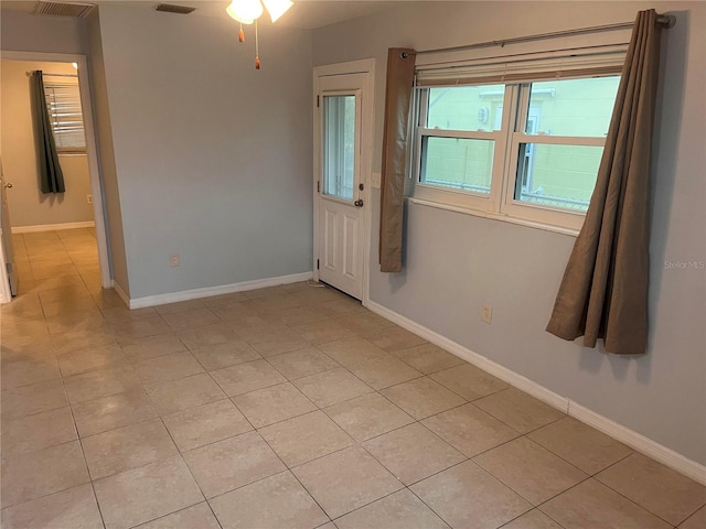 spare room with light tile patterned floors and ceiling fan