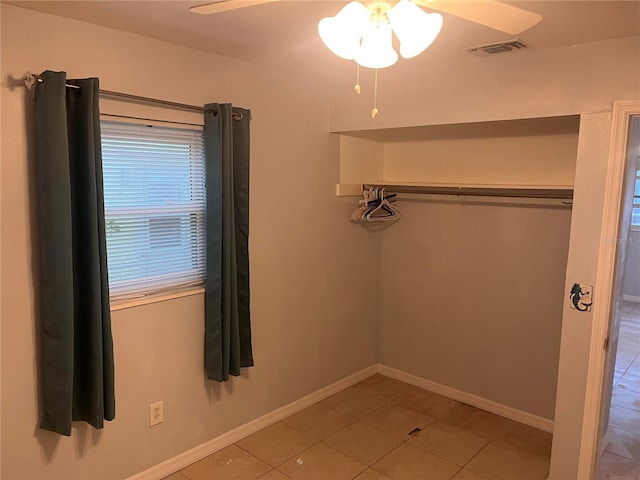 unfurnished bedroom featuring light tile patterned floors and ceiling fan