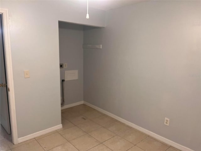 laundry area with light tile patterned flooring