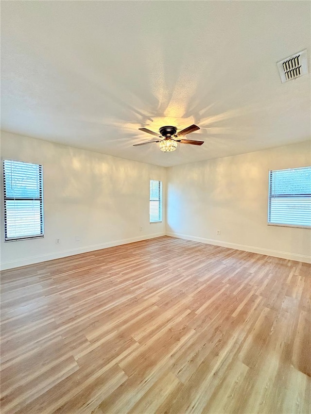 empty room featuring ceiling fan and light hardwood / wood-style floors